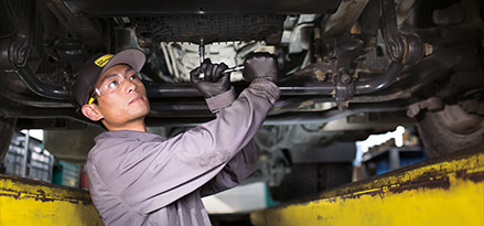  a mechanic fixing the under of a car