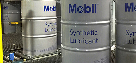 drums of Mobil SHC lubricants in factory