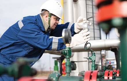 engineer inspecting a dial