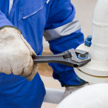 engineer fixing a bolt with spanner