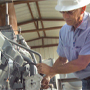engineer in hard hat checking gas engine
