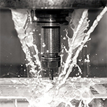 drilling on glass with cutting fluid in machine shop