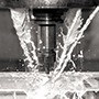 drilling on glass with cutting fluid in machine shop