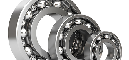 three silver roller ball bearings in different sizes