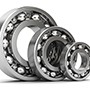 three silver roller ball bearings in different sizes