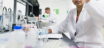 scientist studying sample in lab