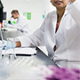 scientist studying sample in lab