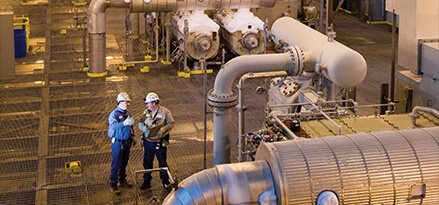 2 men discussing at a factory
