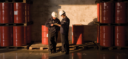 2 engineers with red barrels as background