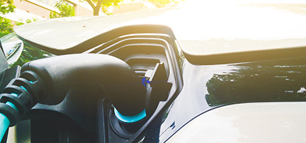 blue electric car with orange charger
