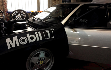 open hood of car with mobil 1 cover