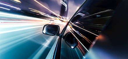 city lights from side view of a moving car