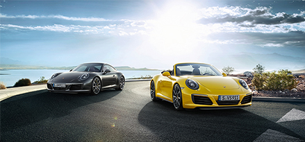 yellow and black porsche car on a sunny road